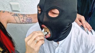 Dominatrix Smokes On Balcony With Man As Ashtray